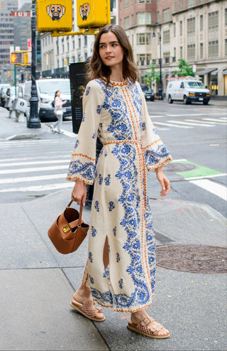 Woman in a floral dress walking on a city street